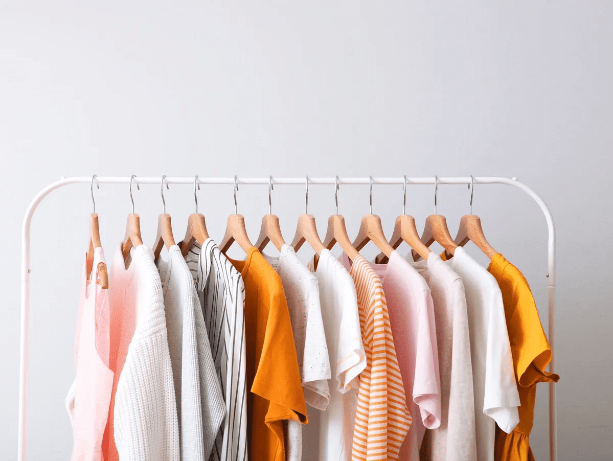 Clothes hanging on a rack.